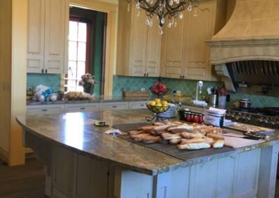 Spacious kitchen with wood cabinets, a central island, and a chandelier.
