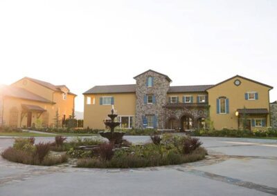 Suburban homes with mediterranean architectural styles during sunset.