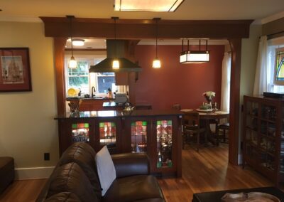 Interior view of a cozy room with craftsman style decor featuring wooden built-ins and pendant lighting.
